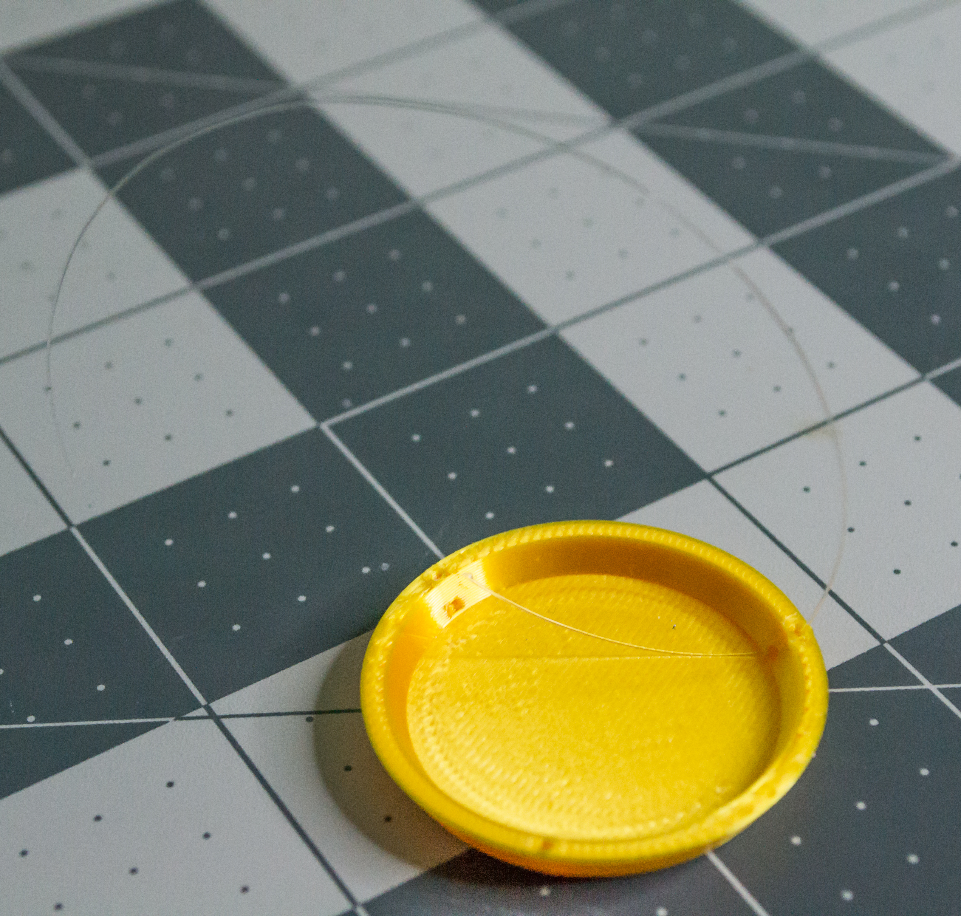 Putting monofilament through a small hole in the 3D printed gold plate for VintageScale.