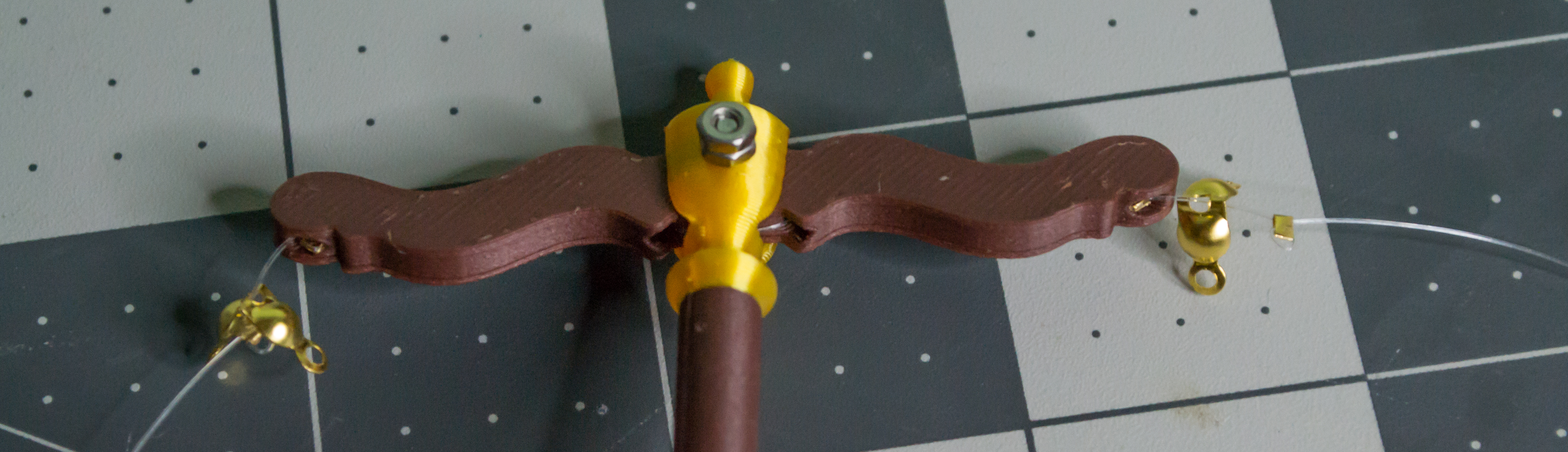 Both sides have a small gold bead crimped at equal positions down their monofilament lines on the VintageScale project.