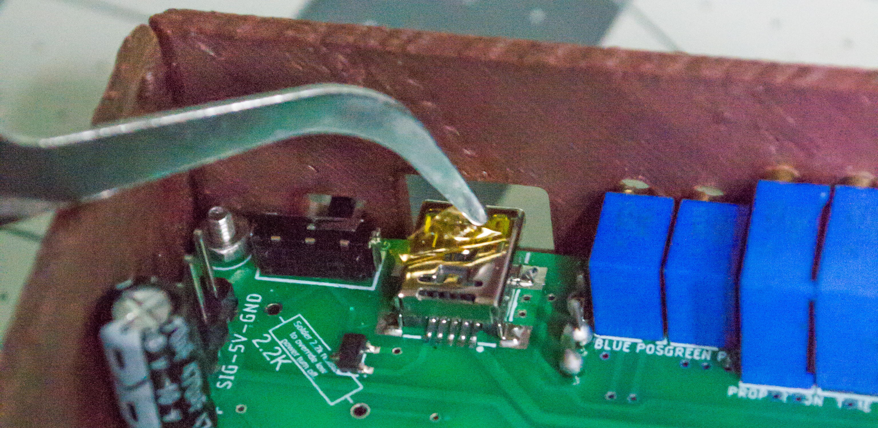 Taking the yellow sticker off a USB Mini-B port.