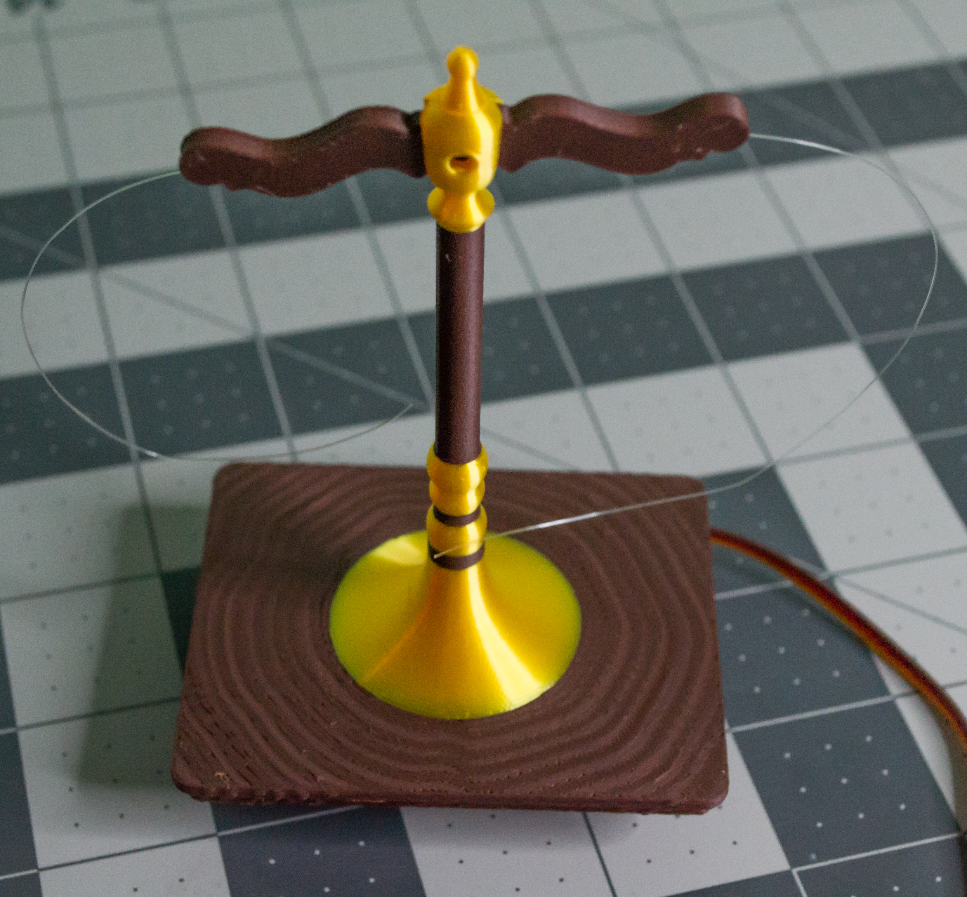 Lever component in place with monofilament running through it and exiting on both sides on VintageScale.