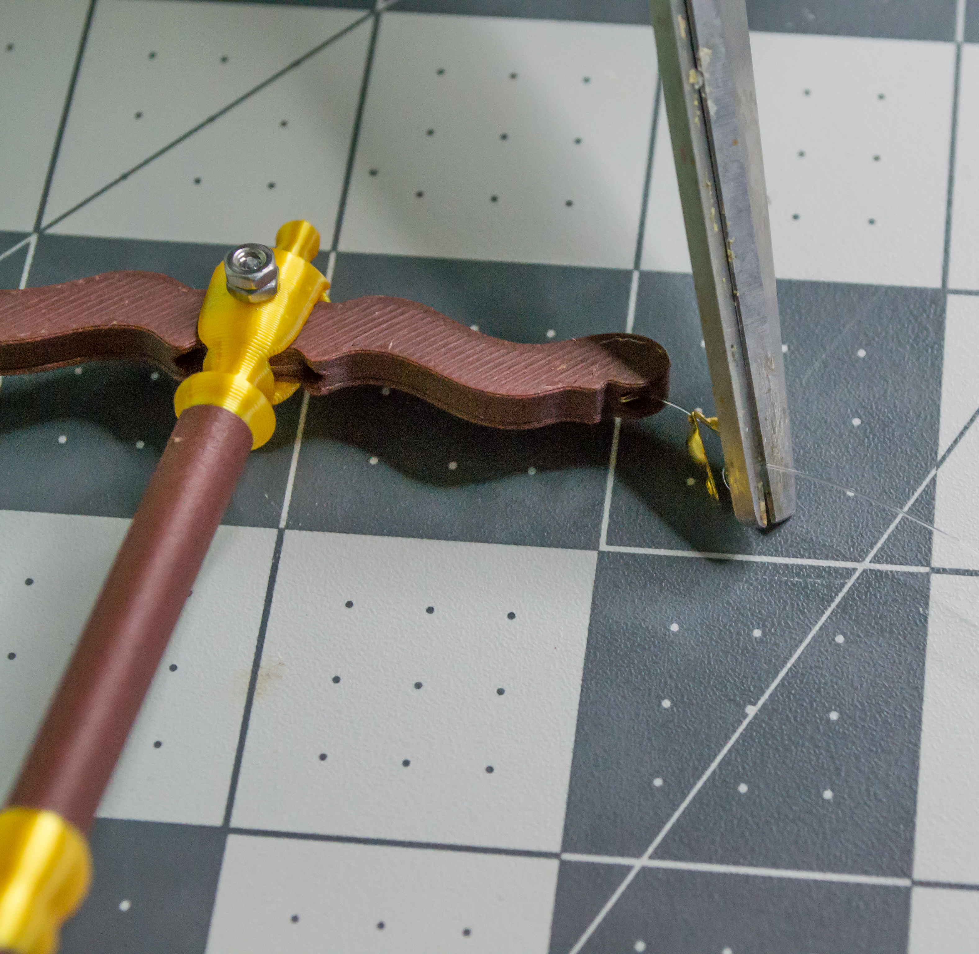 Cutting the excess monofilament line off VintageScale lever component.