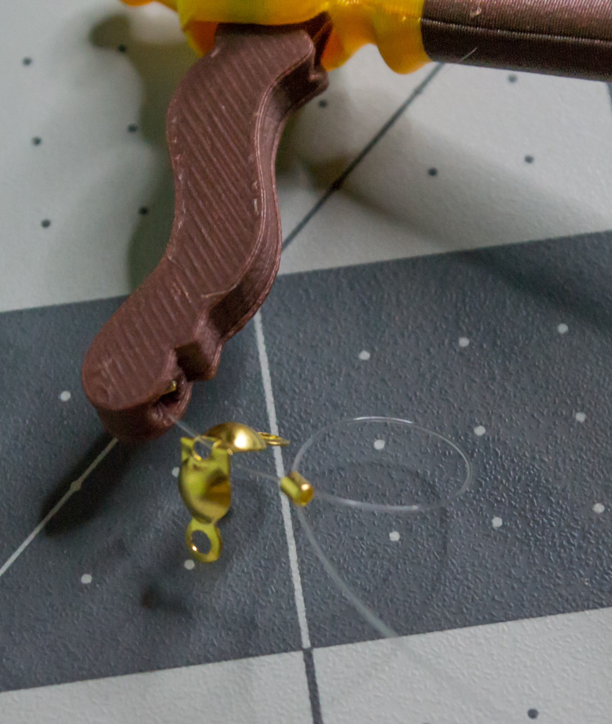 Adding a loop around the gold crimp bead that is right below the gold clamshell bead on the lever component of VintageScale.