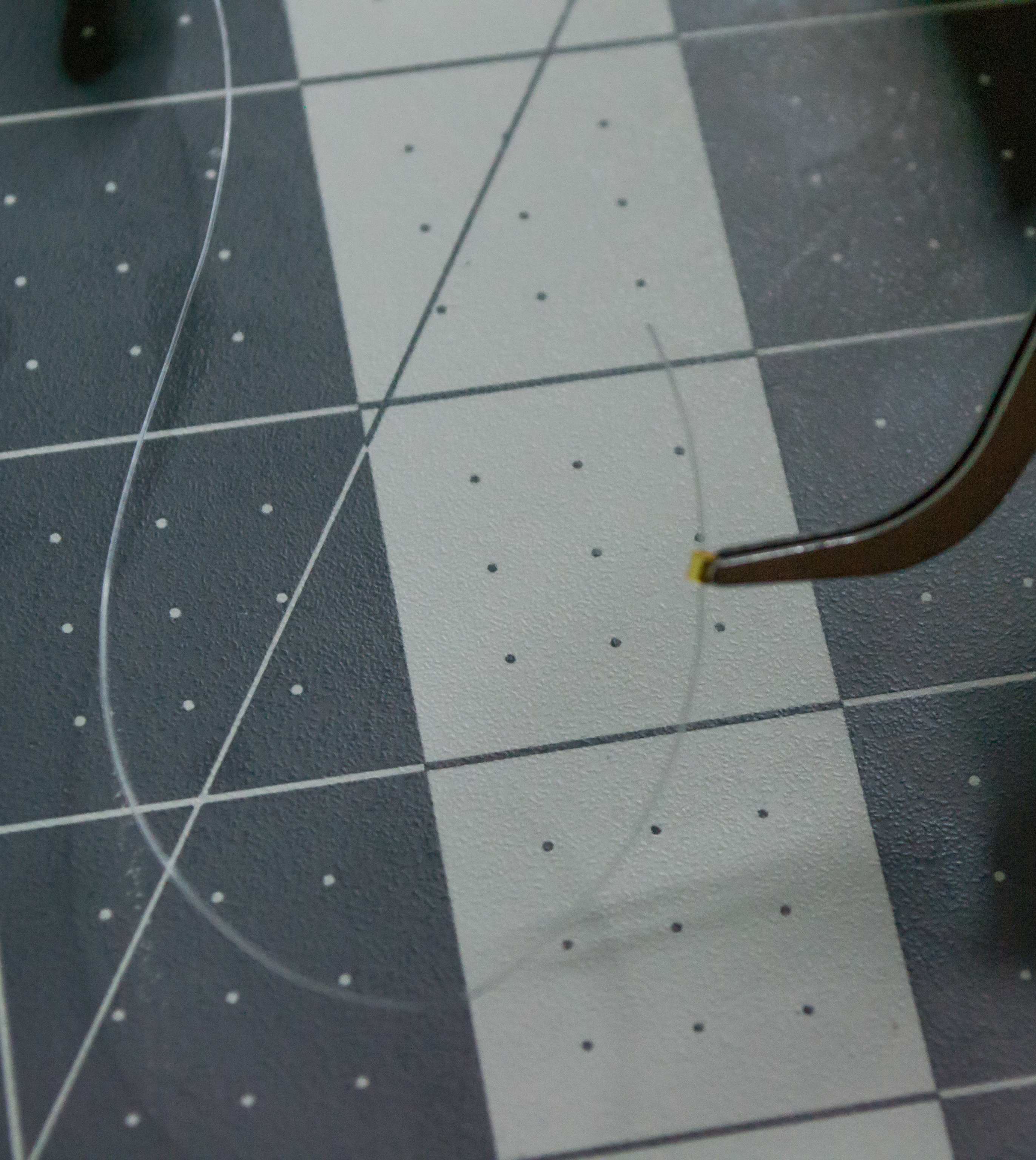 Using the monofilament line from one side of the lever and placing a small gold crimp bead for VintageScale.