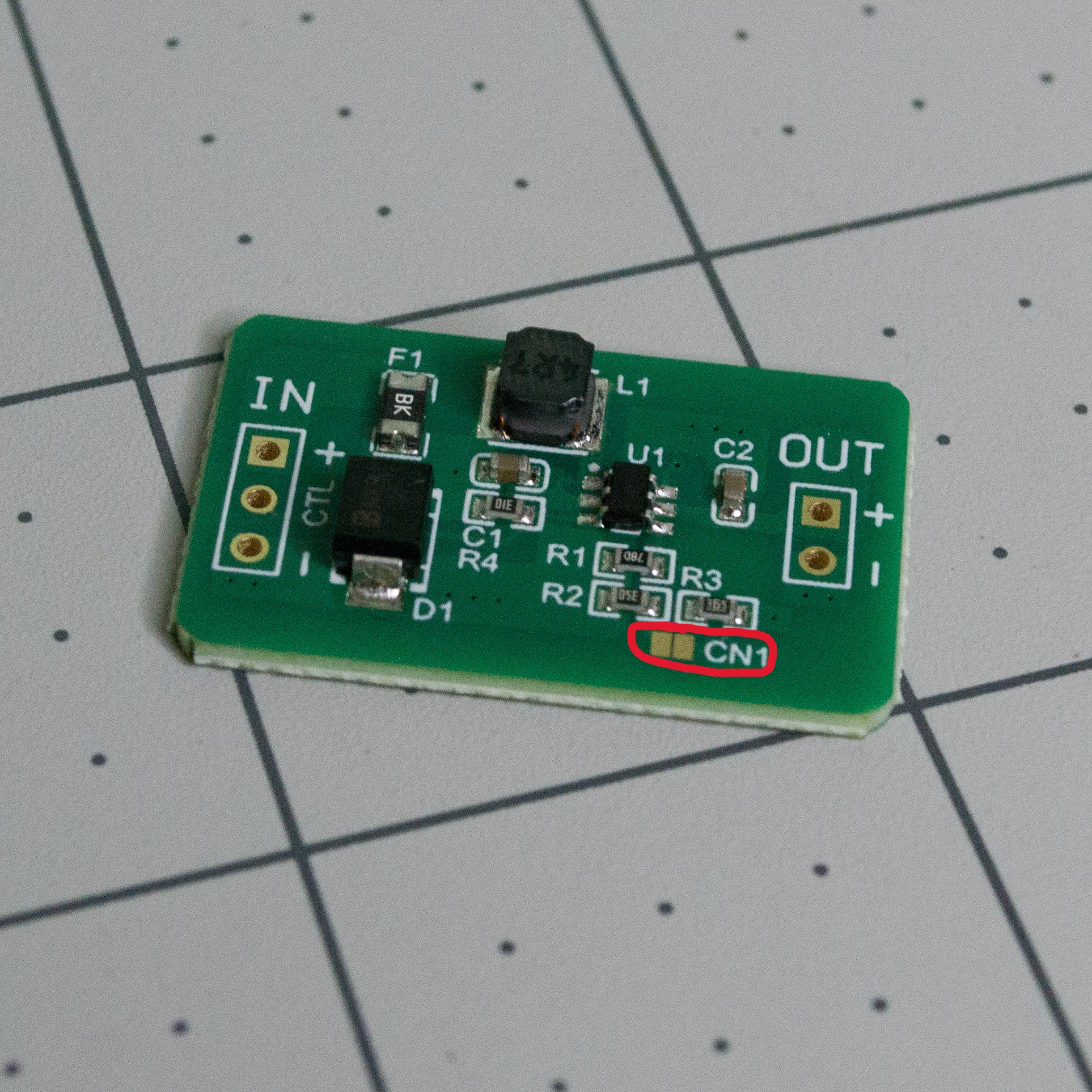 QEBIDUM DC-DC converter board annotated to show CN1 pad to connect with solder to set voltage step up to 5 V.