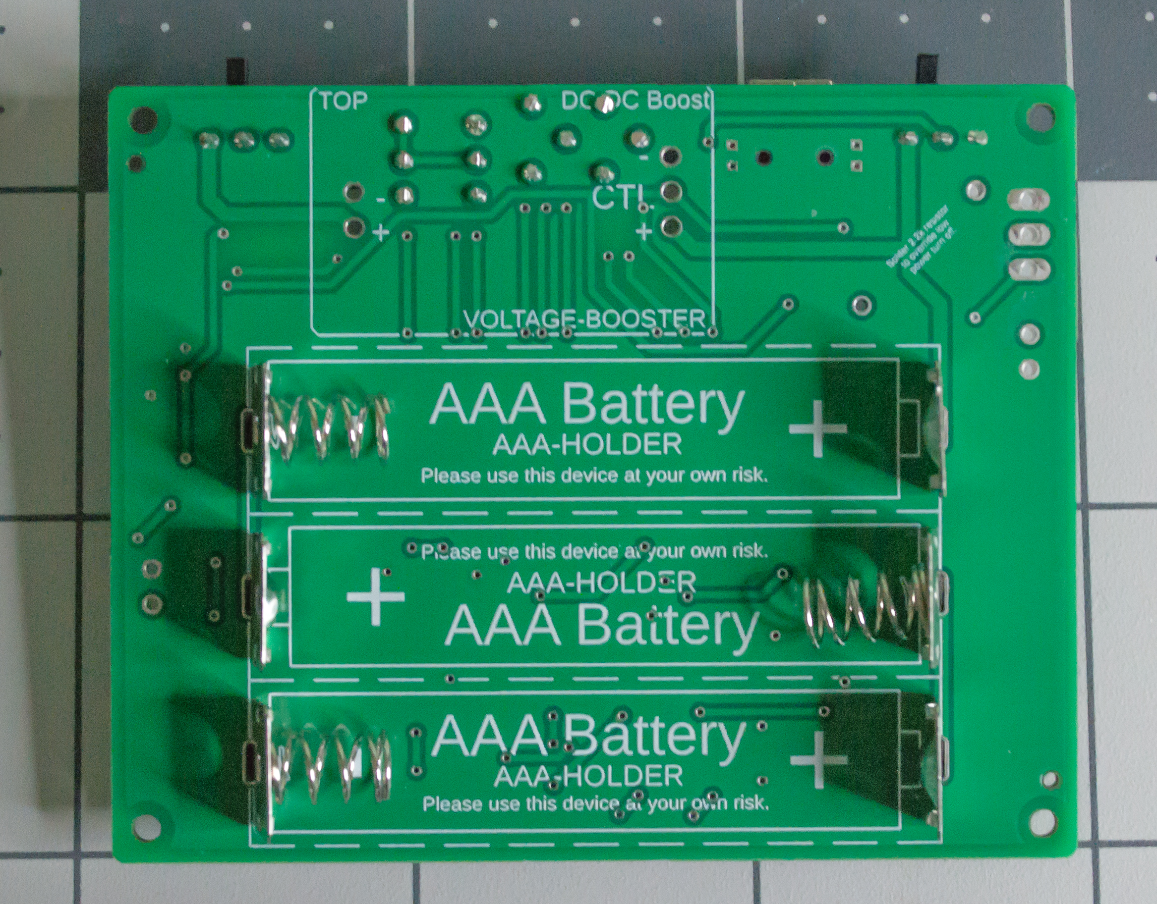 Backside of the TwoPositionServo PCBA with battery contacts placed.