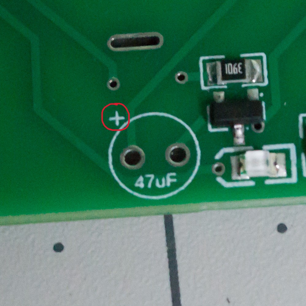 The plus sign circled on the TwoPositionServo controller board for the 47 uF capacitor.